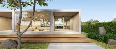 Modern architectural house with concrete pavement in foreground.