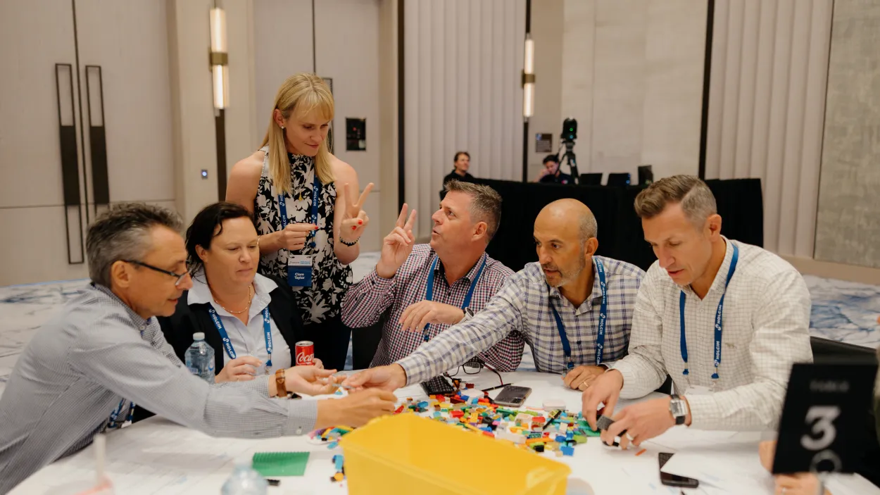 Holcim ANZ leaders collaborate in a hands-on LEGO® team-building activity, reinforcing the Holcim Spirit of Purpose, People, and Performance.