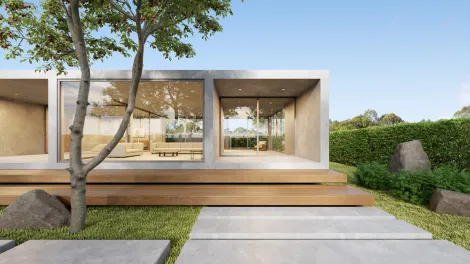 Modern architectural house with concrete pavement in foreground.